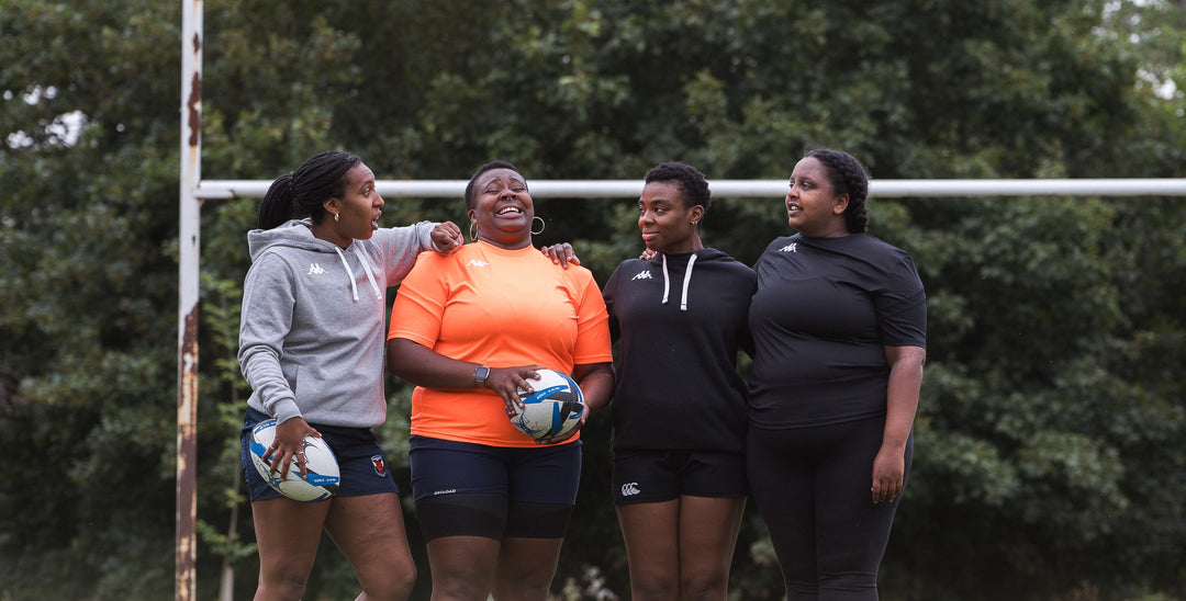 Black Girls Ruck group stood on pitch in front of the posts