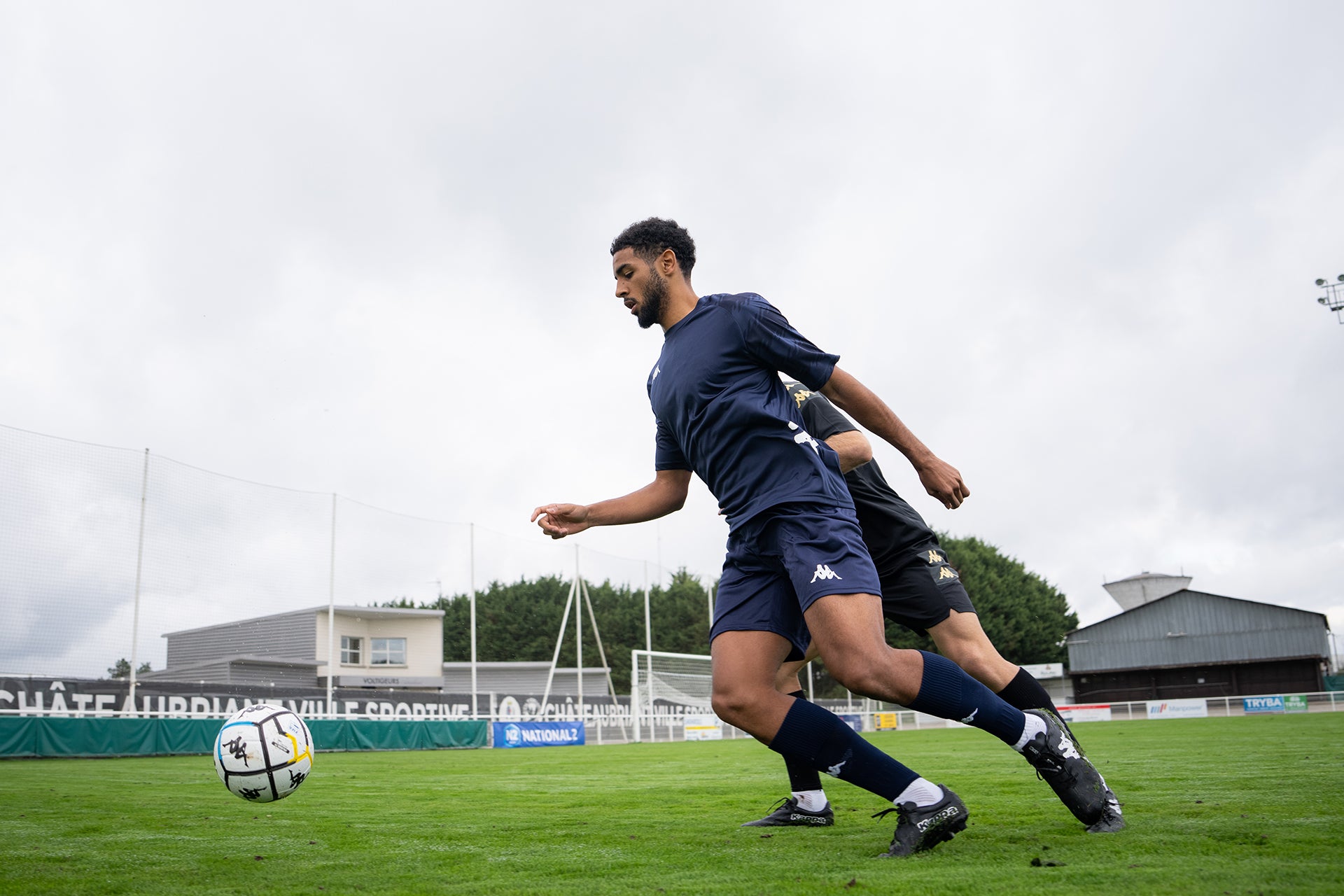 Two male footballers playing in the Kappa® kit.